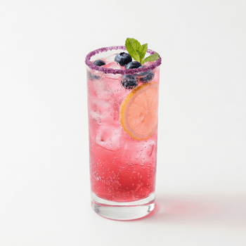 The beverage is a vibrant, translucent pink-purple with visible carbonation, topped with fresh blueberries and a mint sprig. The glass features a precise, deep purple blueberry sugar rim and a fresh lemon slice inside.