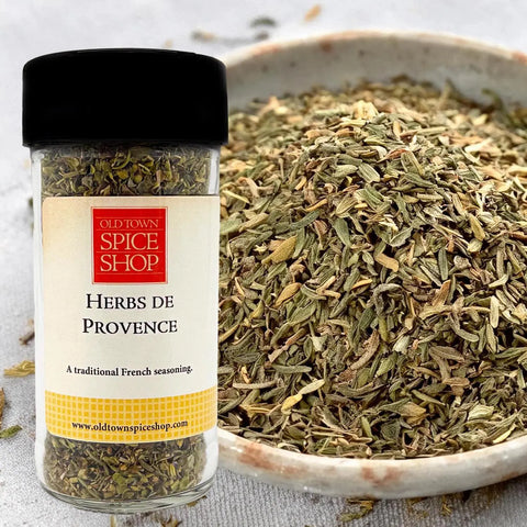 Jar of Old Town Spice Shop Herbs de Provence with a bowl of dried herbs on a light background