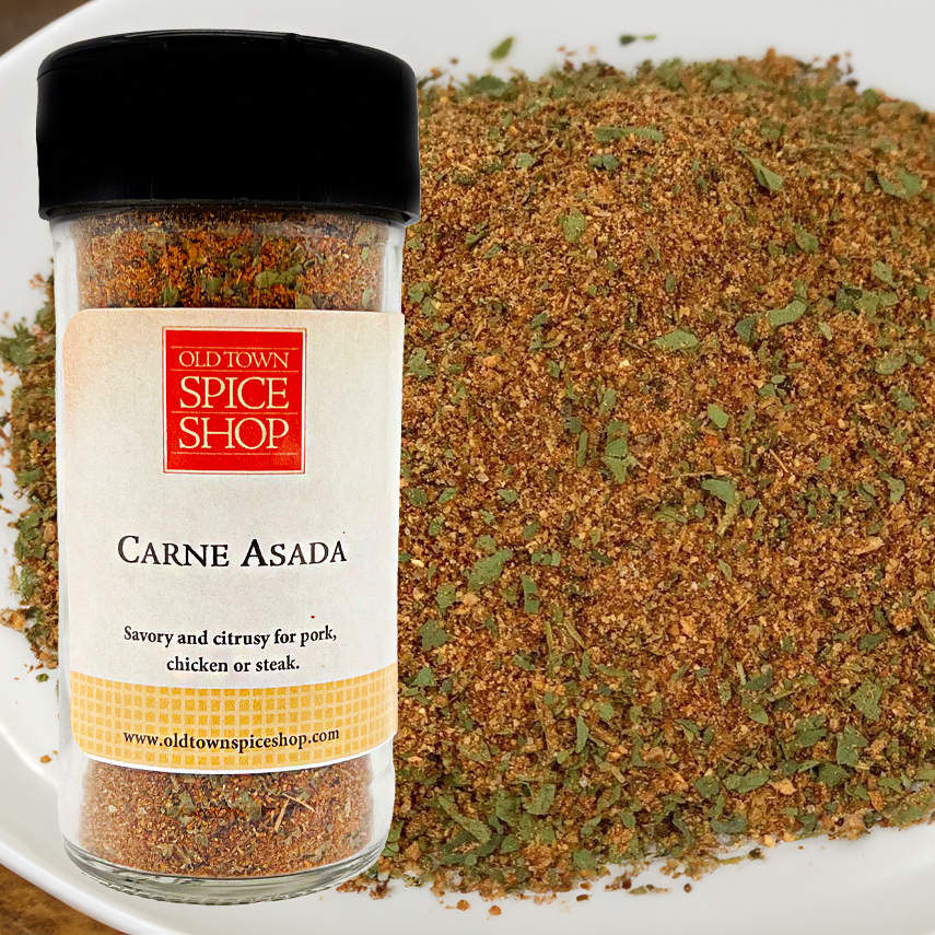 Spice jar labeled 'Carne Asada' from Old Town Spice Shop with spice mix in the background.