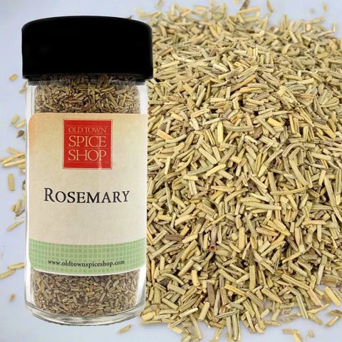 Jar of rosemary from Old Town Spice Shop with scattered rosemary on a light background