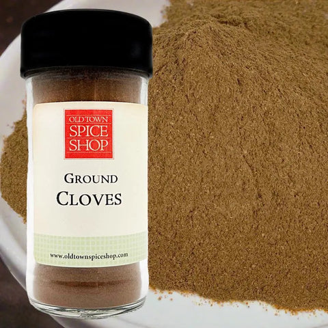 Jar of ground cloves from Old Town Spice Shop with a close-up of the spice in the background.