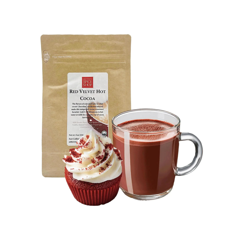 Red Velvet Hot Cocoa package, cup of hot cocoa, and red velvet cupcake on a white background