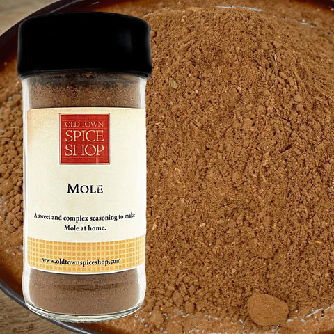 Jar of Old Town Spice Shop Mole spice with a close-up of the spice in the background.