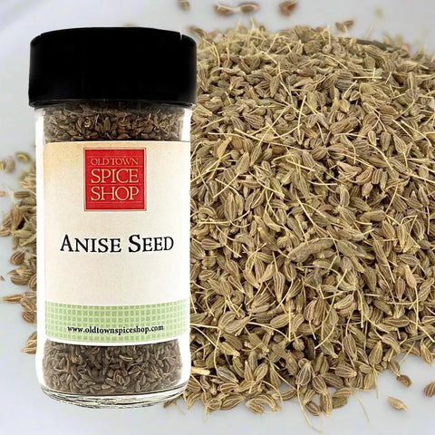 Jar of anise seed with Old Town Spice Shop label next to a pile of anise seeds.