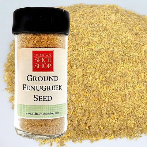 Jar of ground fenugreek seed with a visible label on a light blue background