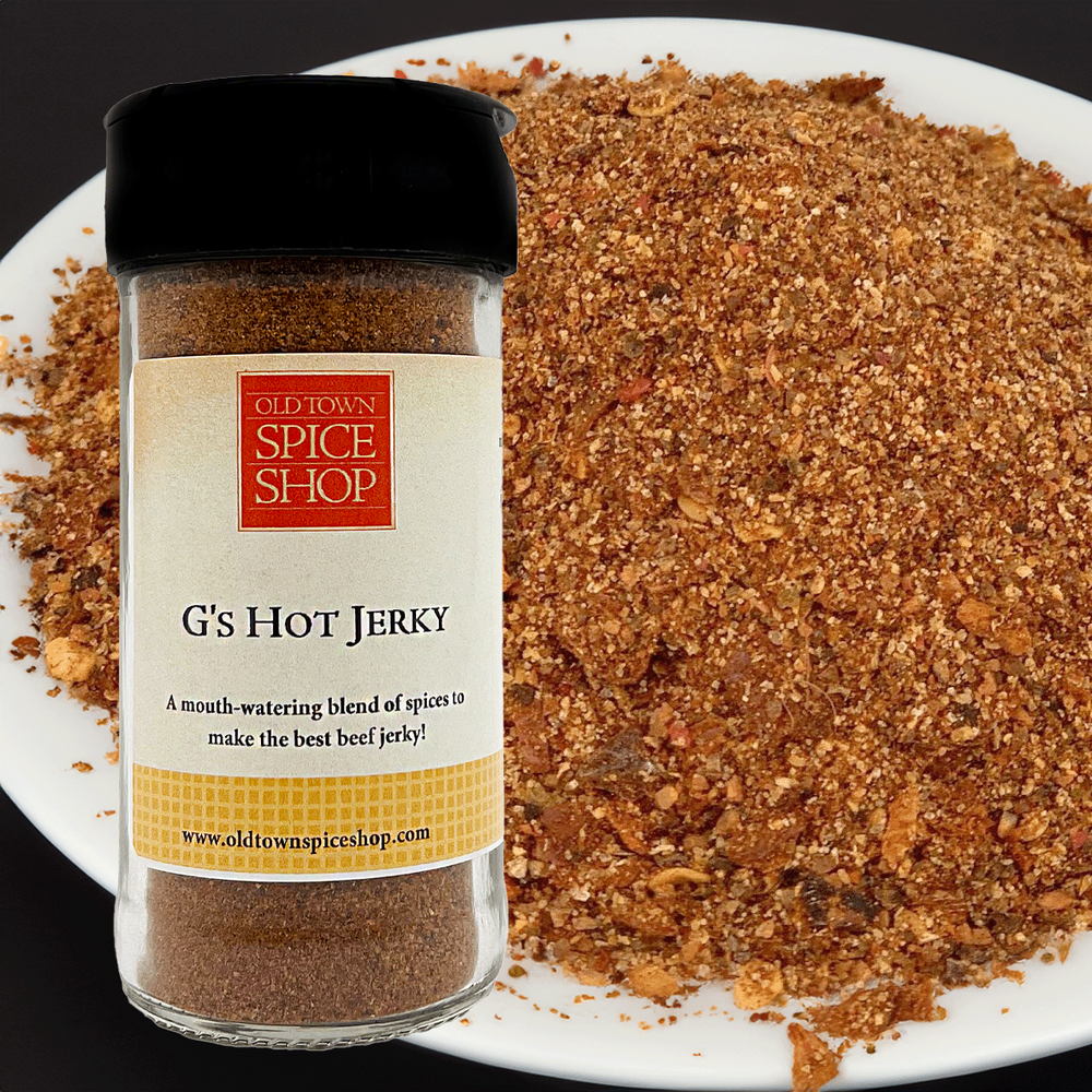 Spice jar labeled 'G's Hot Jerky' from Old Town Spice Shop on a plate of ground spice.