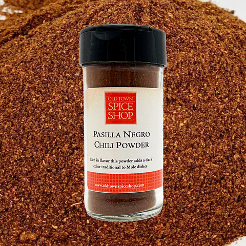 Jar of Pasilla Negro Chili Powder from Old Town Spice Shop on a chili powder background