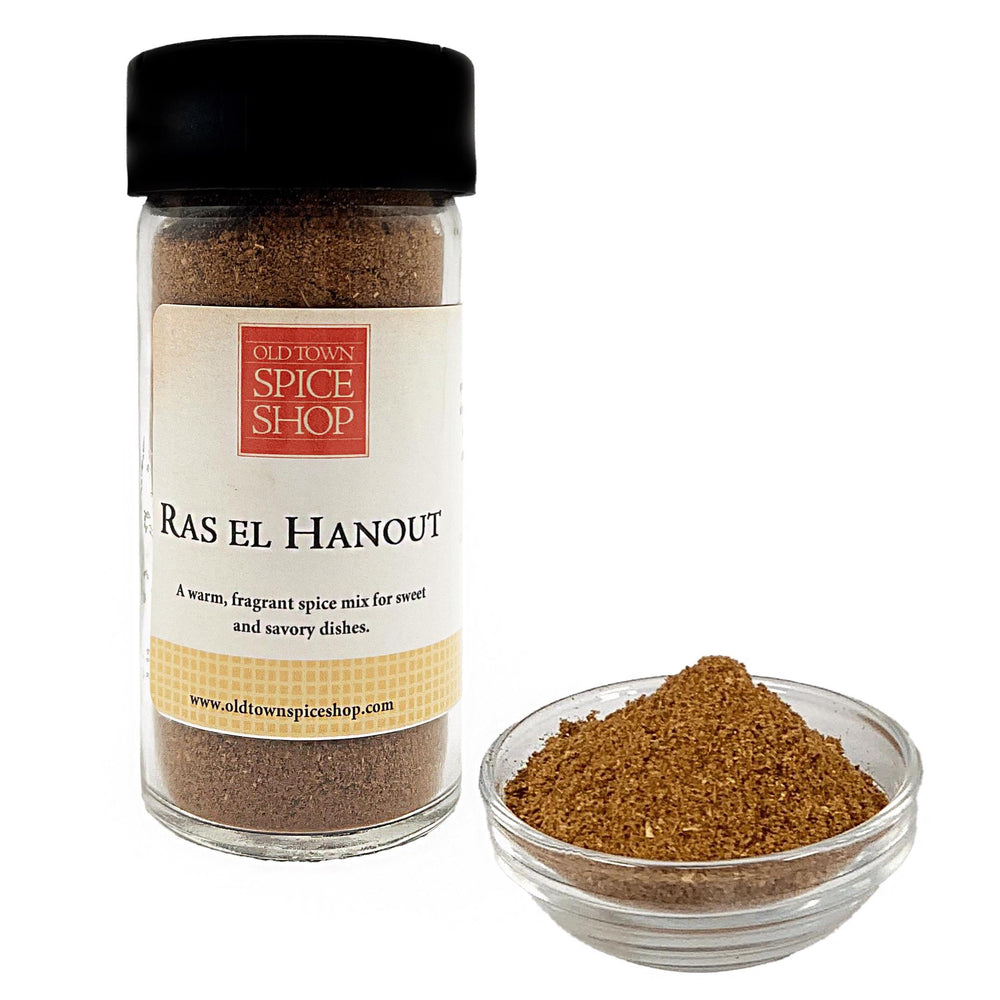 
                      
                        Jar of Old Town Spice Shop Ras El Hanout spice mix with a small bowl of spice on a white background
                      
                    