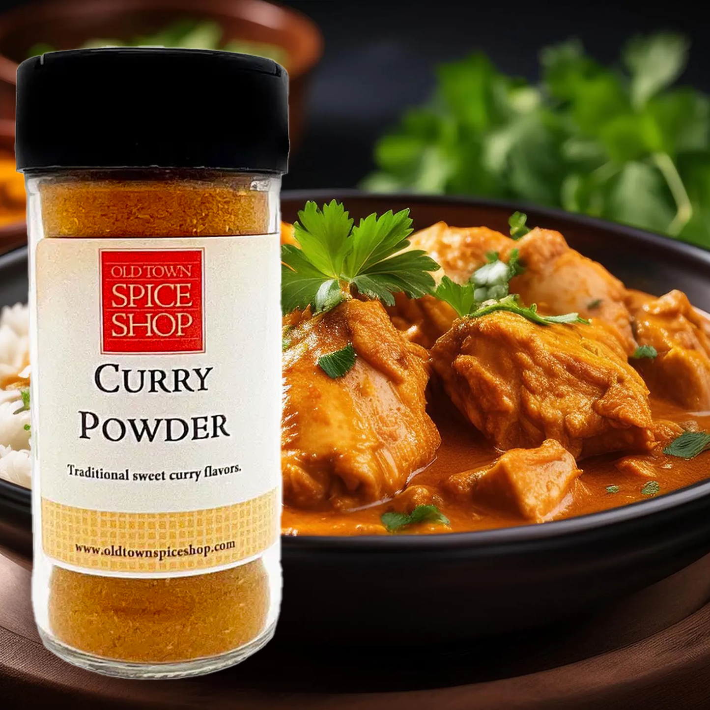 Jar of Old Town Spice Shop Curry Powder with a dish of curry chicken in the background