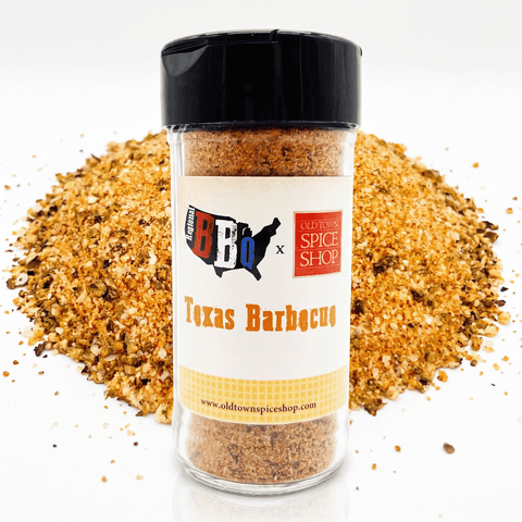 A clear plastic spice jar labeled Texas Barbecue with a black lid, shown in front of a pile of the seasoning blend on a white background.