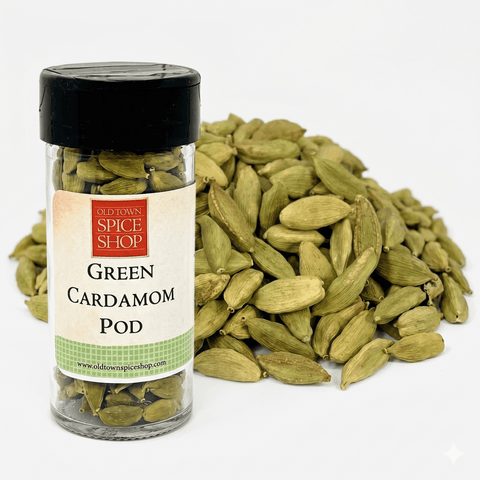 A clear glass jar filled with vibrant green cardamom pods, featuring a clean white label and a black lid, isolated on a white background.