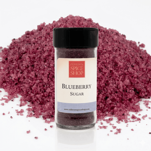 Jar of blueberry sugar from Old Town Spice Shop with a pile of blueberry sugar in the background.