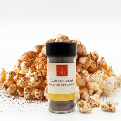 Dark Chocolate Popcorn Seasoning jar with popcorn on a white background