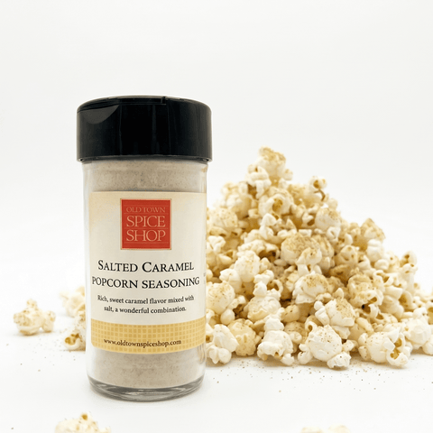 Salted Caramel Popcorn Seasoning container with popcorn on a white background