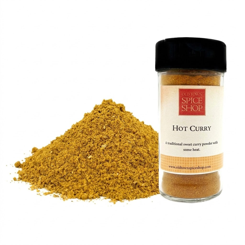 Hot Curry spice jar with a pile of curry powder on a white background