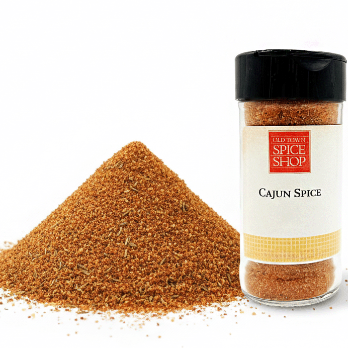 Jar of Cajun spice from Old Town Spice Shop with spilled spice on a white background