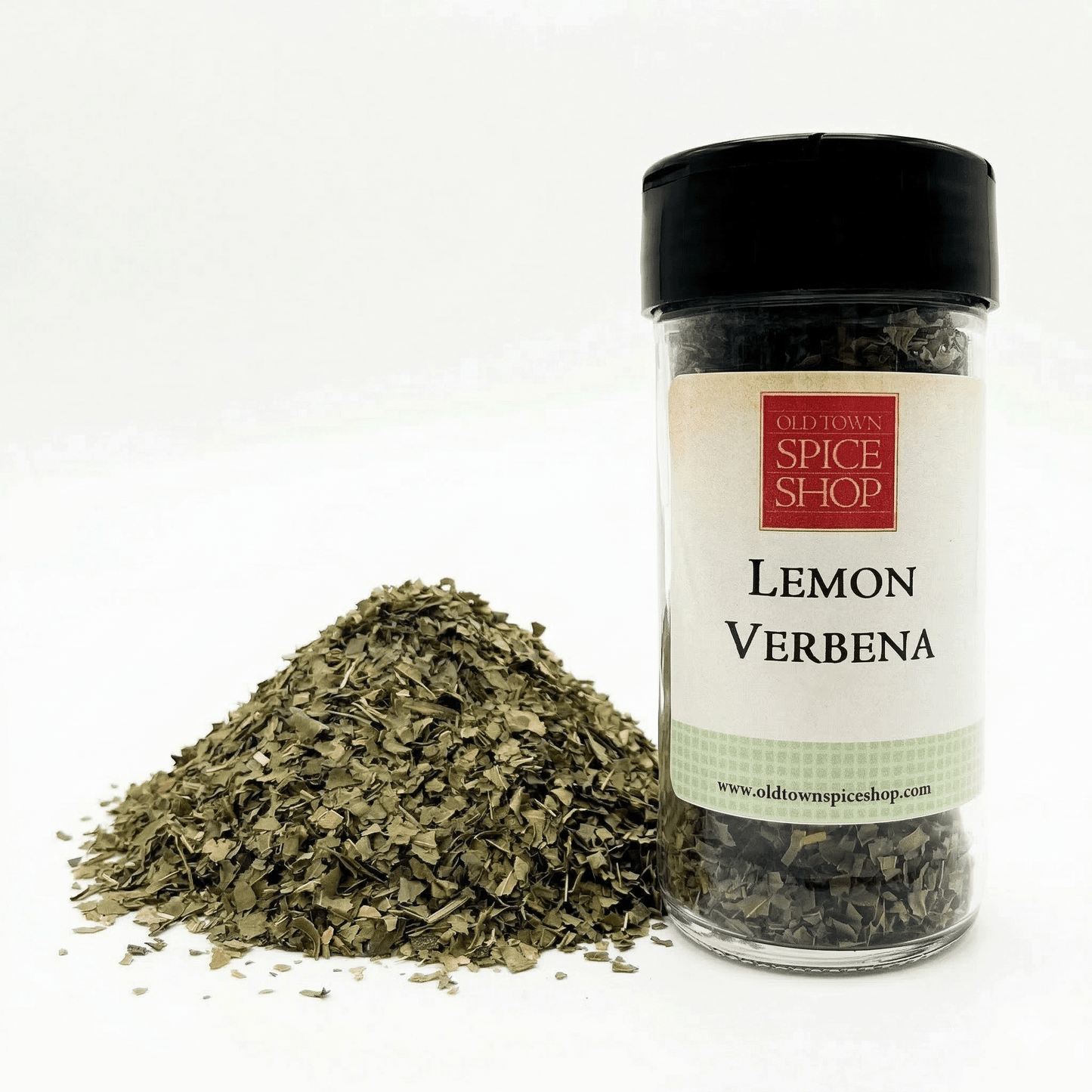 Jar of lemon verbena spice from Old Town Spice Shop with a pile of dried leaves on a white background