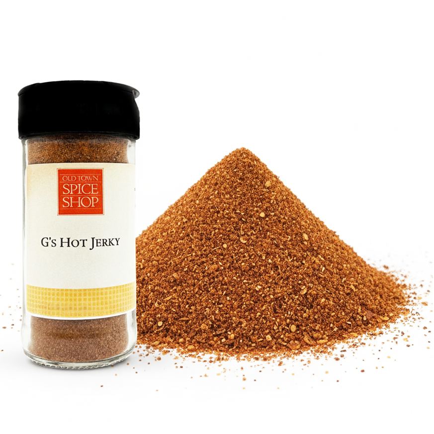 Spice jar labeled 'G's Hot Jerky' from Old Town Spice Shop with spilled spice on a white background