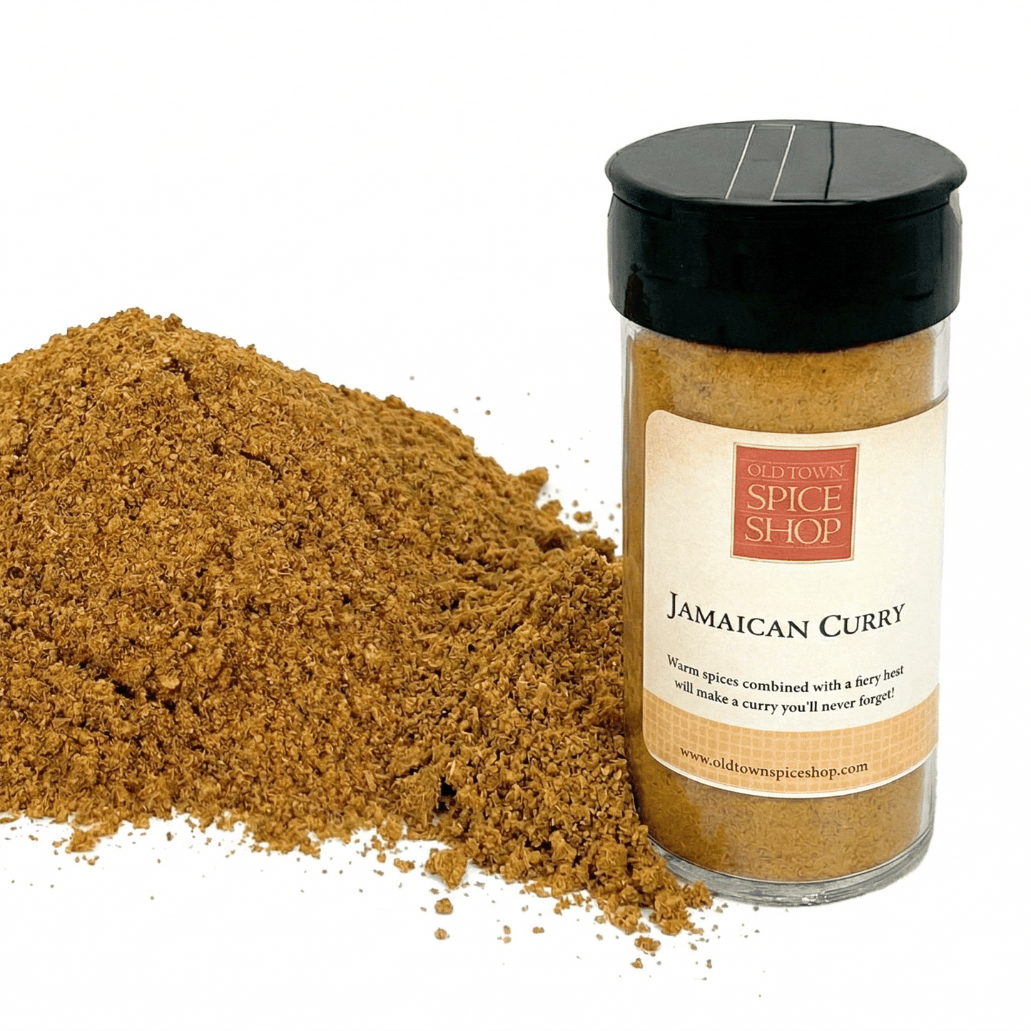 Jamaican Curry spice jar from Old Town Spice Shop with a pile of curry powder on a white background