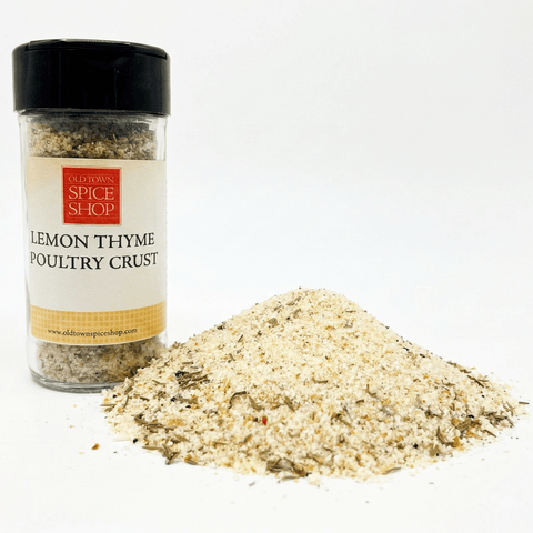 Spice jar labeled 'Lemon Thyme Poultry Crust' from Old Town Spice Shop with a pile of spice mix on a white background.