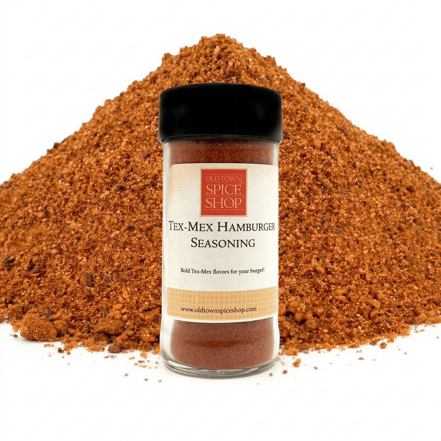 Jar of Tex-Mex Hamburger Seasoning from Old Town Spice Shop with a pile of seasoning in the background.