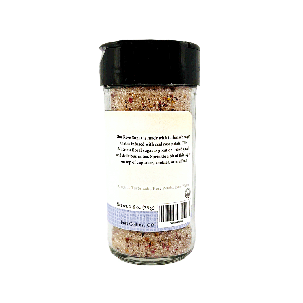 Glass container of rose sugar with a black lid on a white background