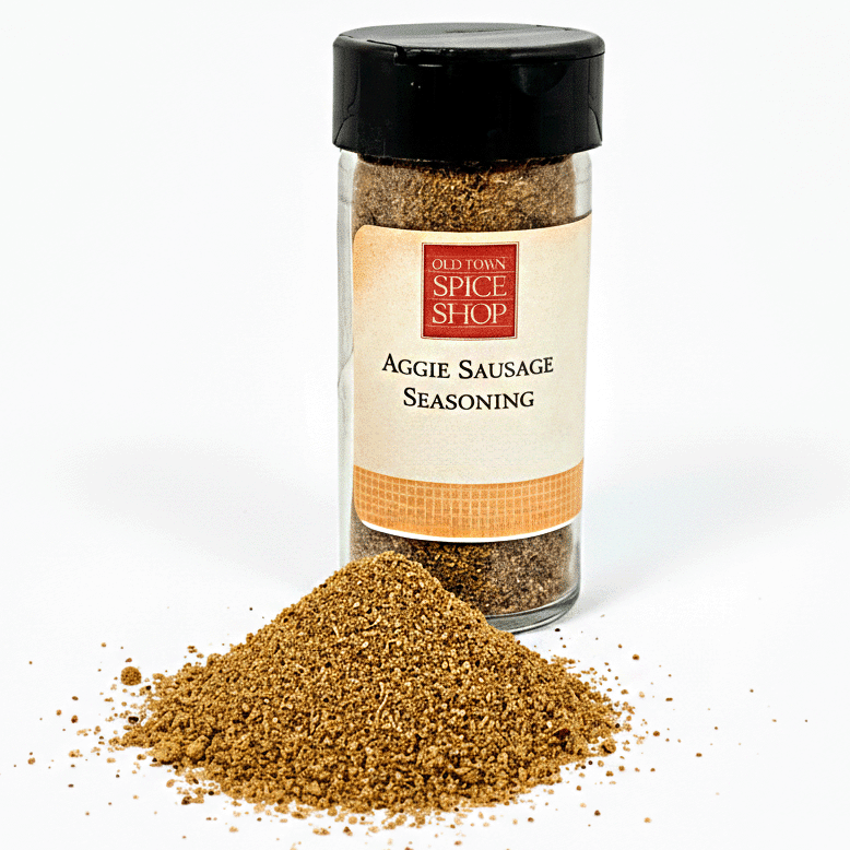 Jar of Aggie Sausage Seasoning from Old Town Spice Shop with spilled seasoning on a white background