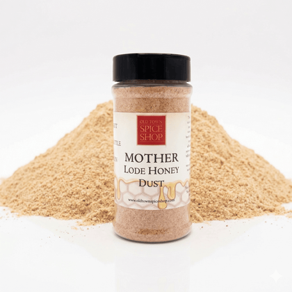 Mother lode honey dust jar in front of spices