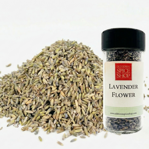 Bottle of lavender flowers from Old Town Spice Shop with a pile of dried lavender on a white background