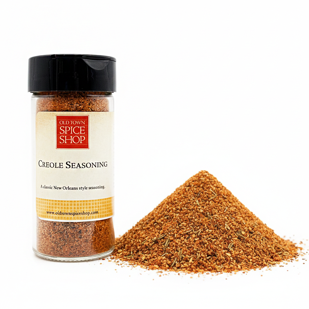 Jar of Old Town Spice Shop Creole Seasoning with spilled seasoning on a white background