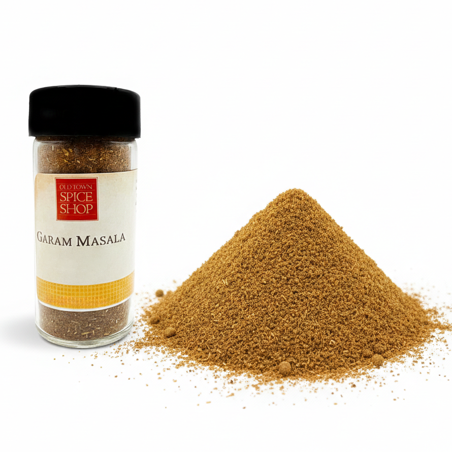 Garam Masala spice jar with a pile of ground spice on a white background