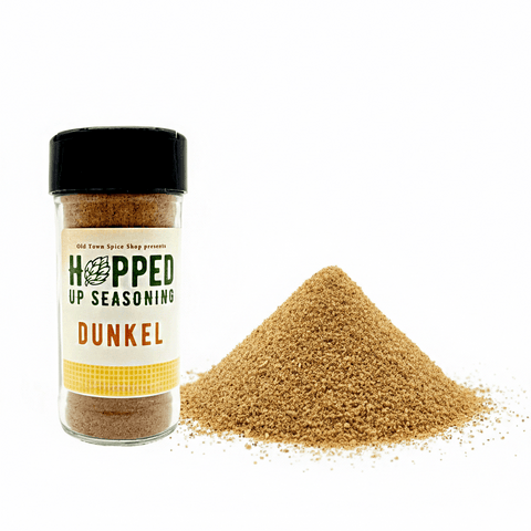 Jar of 'Hopped Up Seasoning Dunkel' with spilled seasoning on a white background
