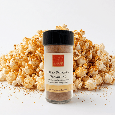 Pizza Popcorn Seasoning container with a pile of popcorn on a white background