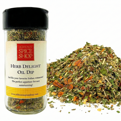 Herb Delight Oil Dip from Old Town Spice Shop with a jar and scattered herbs on a white background