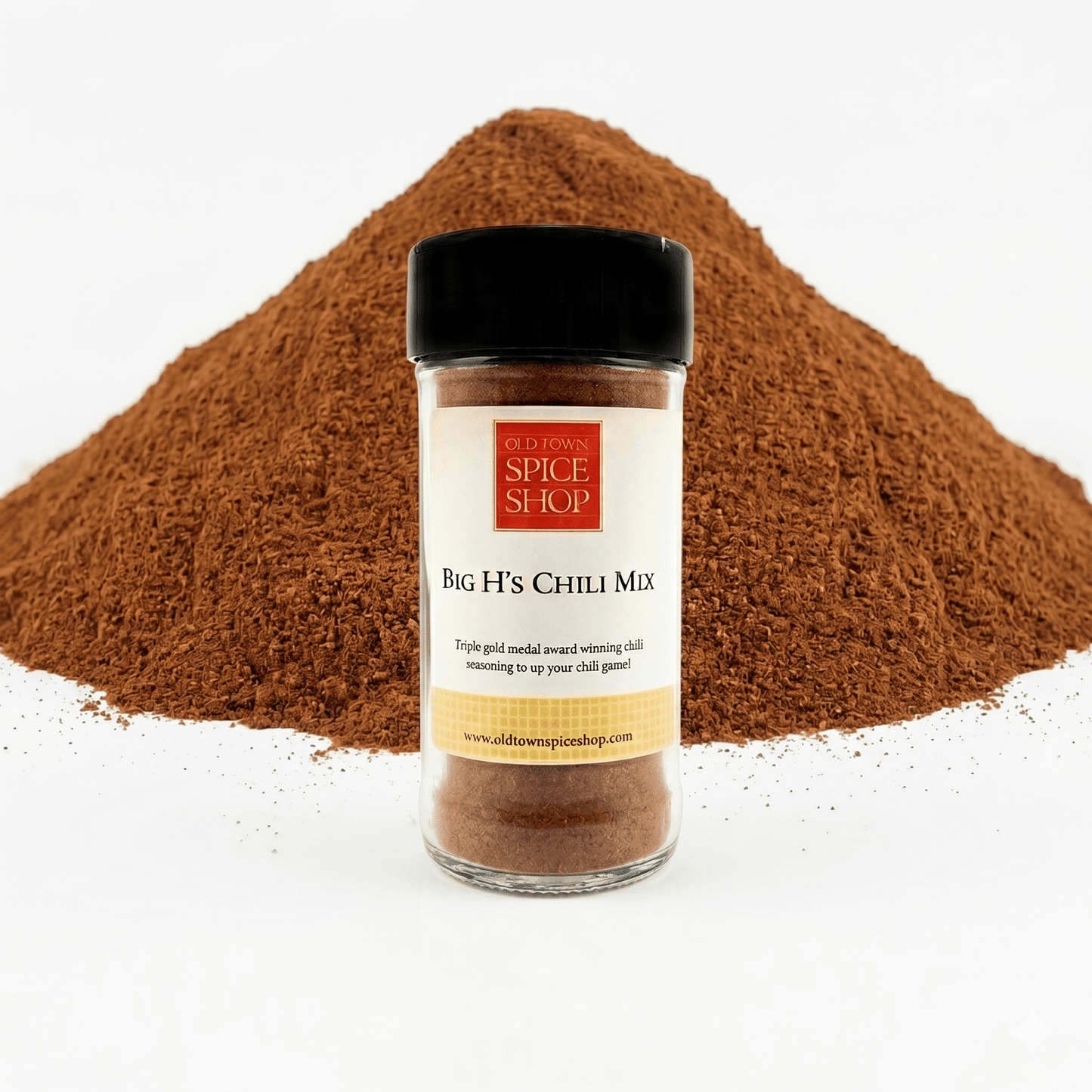 Jar of Big H's Chili Mix from Old Town Spice Shop with chili powder in the background