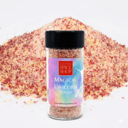 Jar of 'Magical Unicorn Sugar' from Old Town Spice Shop with colorful sugar in the background.