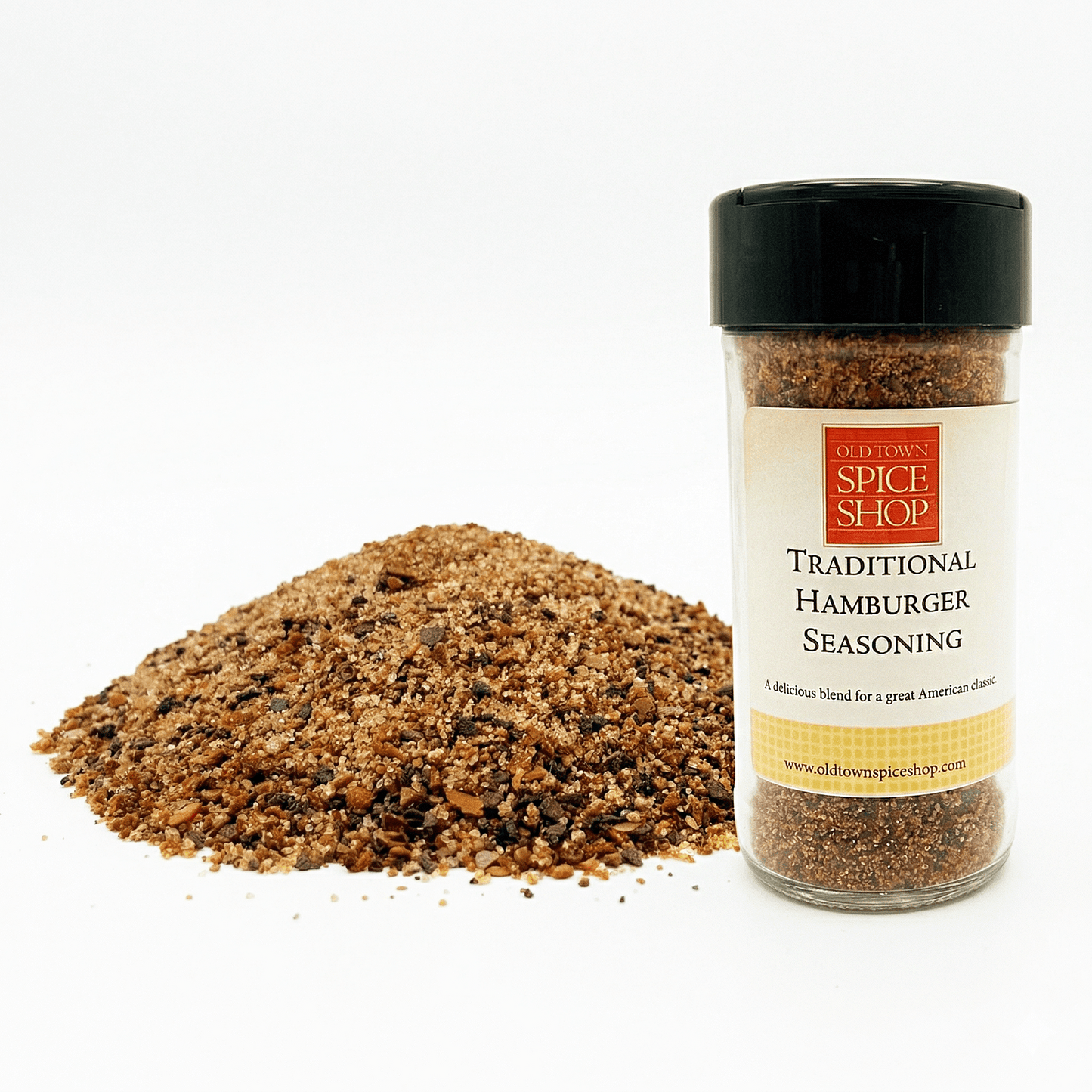 Jar of Old Town Spice Shop Traditional Hamburger Seasoning with spilled seasoning on a white background