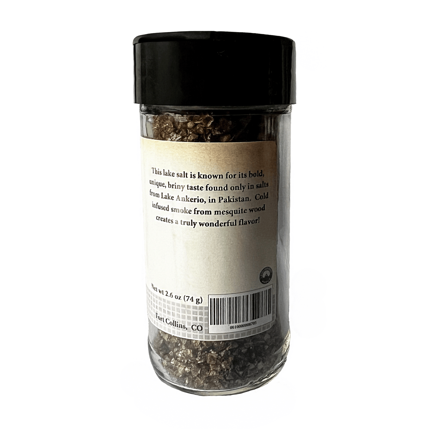 Glass container of lake salt with black lid on a white background