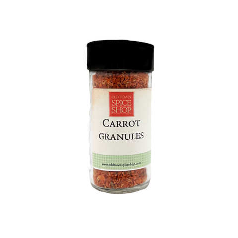 Jar of carrot granules from The Spice Shop on a white background