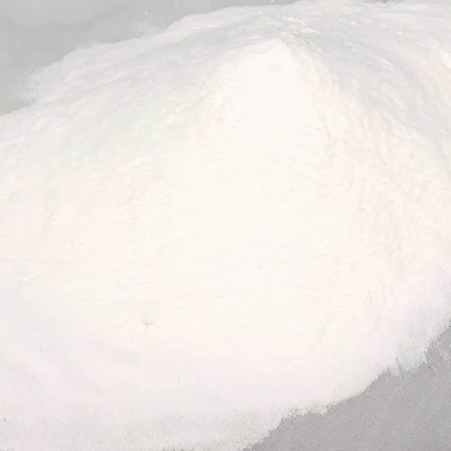Close-up of a fluffy white powder against a gray background