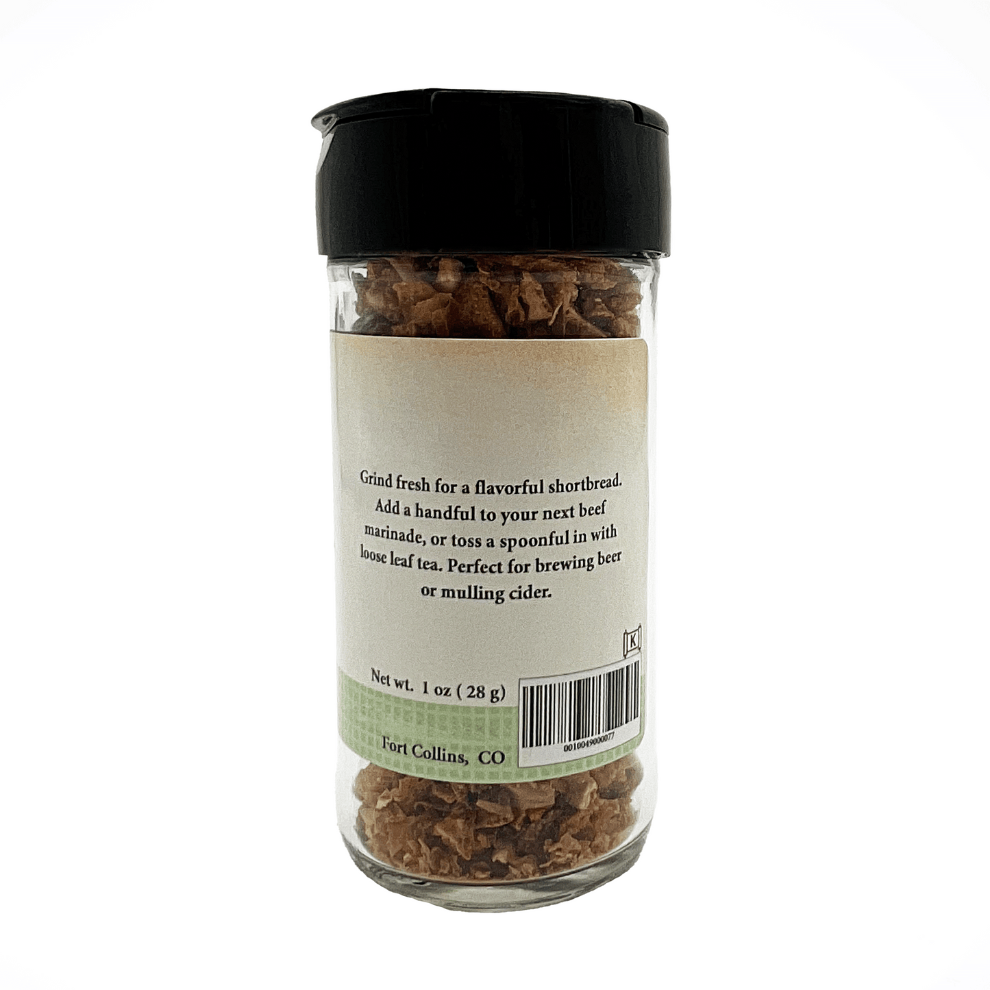 Glass jar with black lid containing dried herbs or spices, labeled 'Fort Collins, CO'.