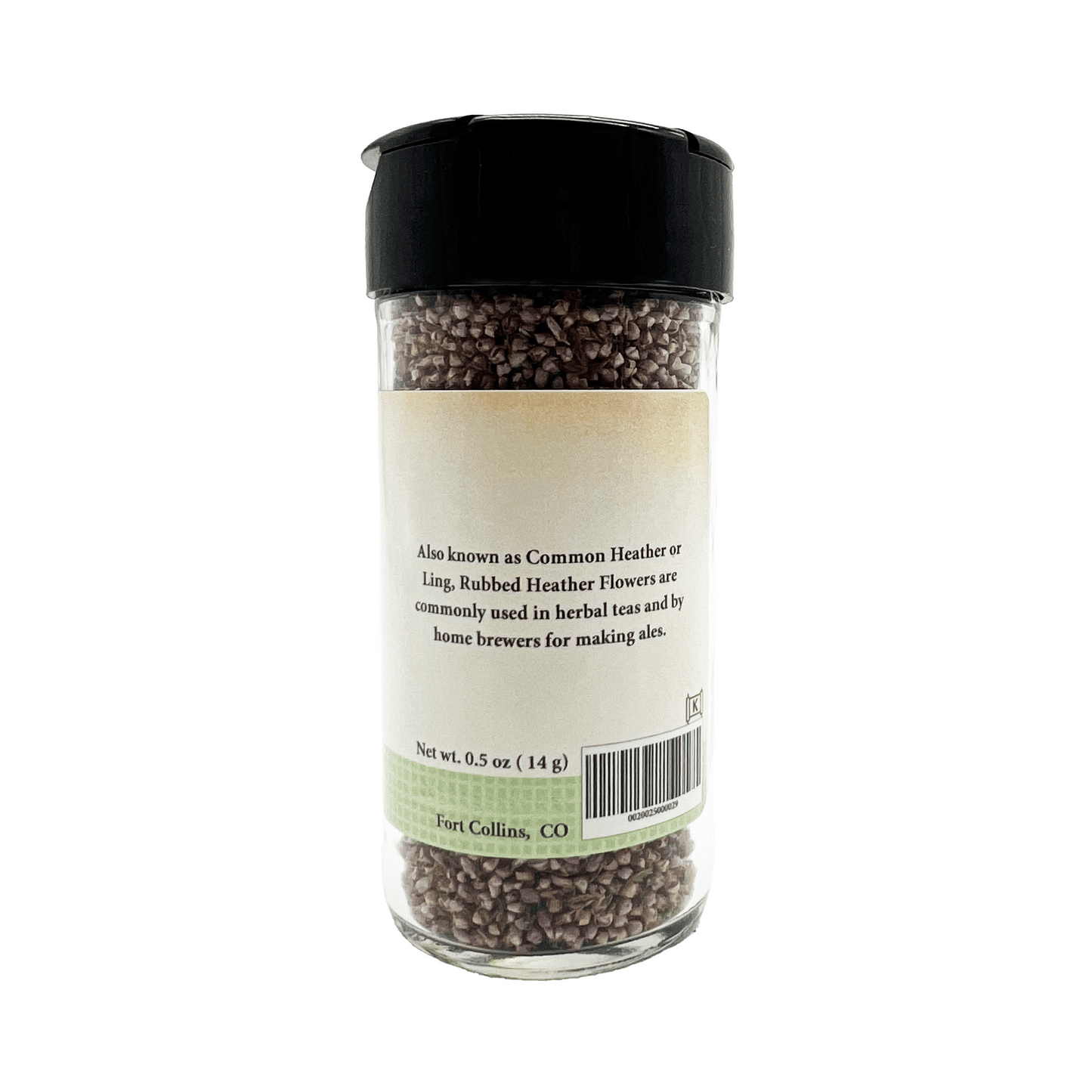 Glass jar with black lid containing small flower buds, on a white background.