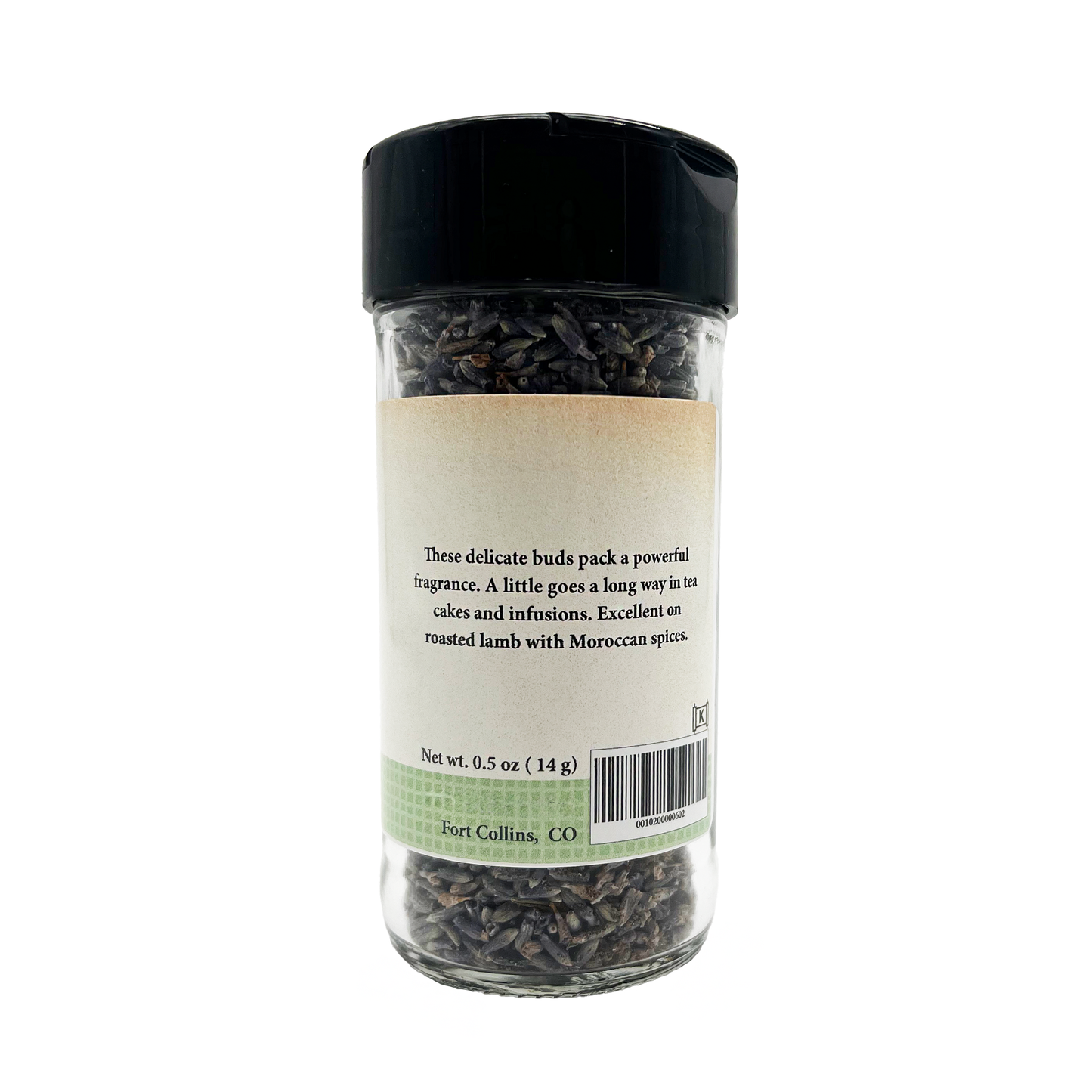 Glass jar of dried lavender buds with a black lid on a white background