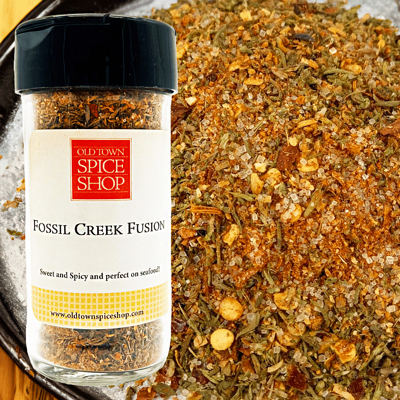 Spice jar labeled 'Fossil Creek Fusion' from Old Town Spice Shop on a bed of spices.