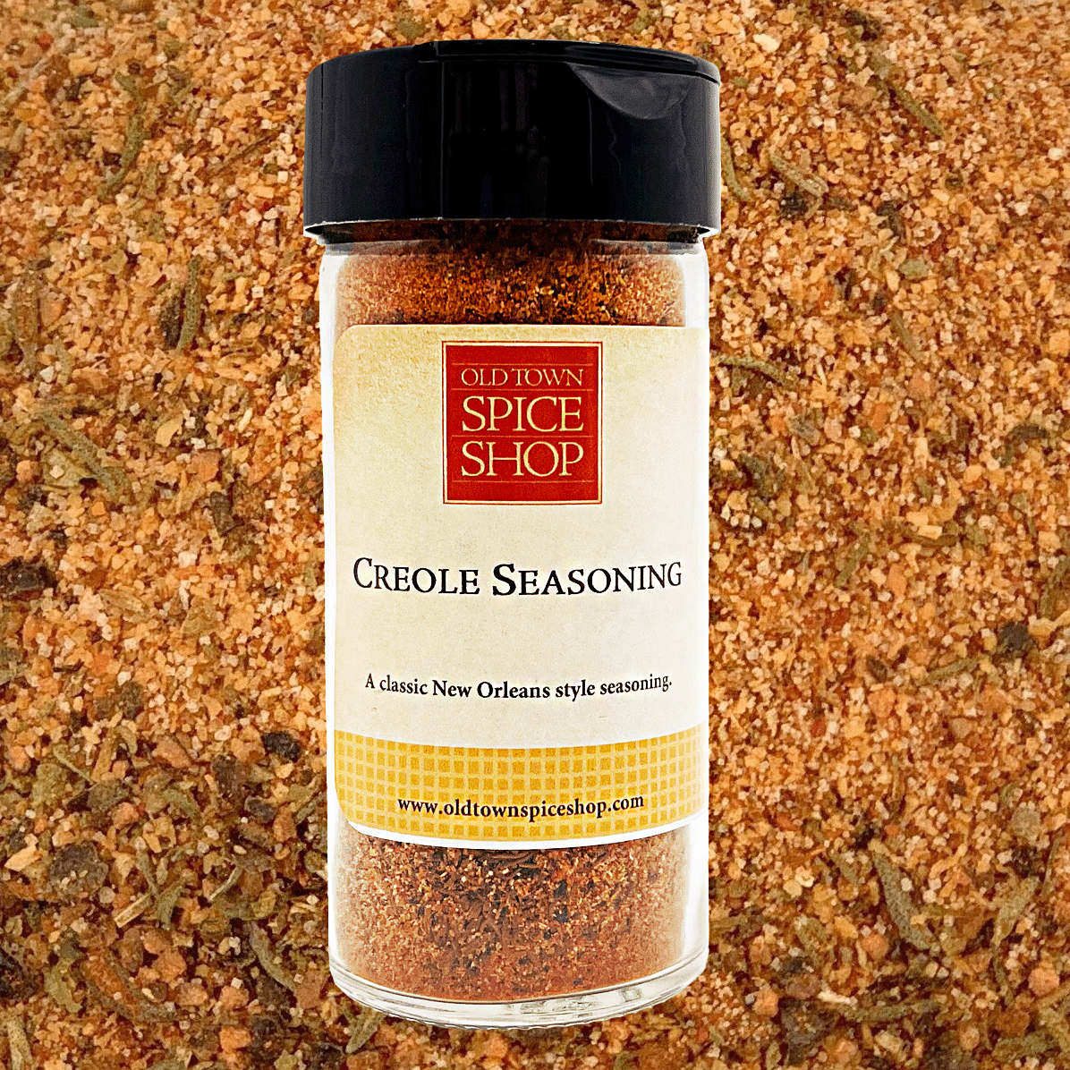 Jar of Old Town Spice Shop Creole Seasoning on a textured spice background