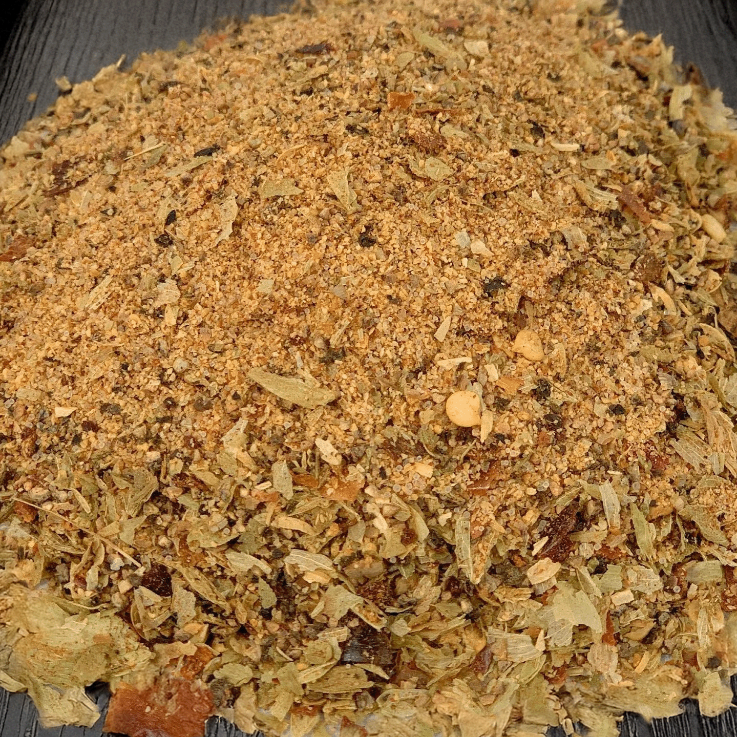 Dry herb mix on a black surface