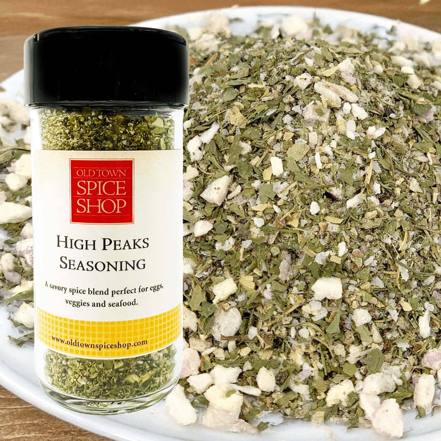Jar of Old Town Spice Shop High Peaks Seasoning with a pile of seasoning on a white plate.