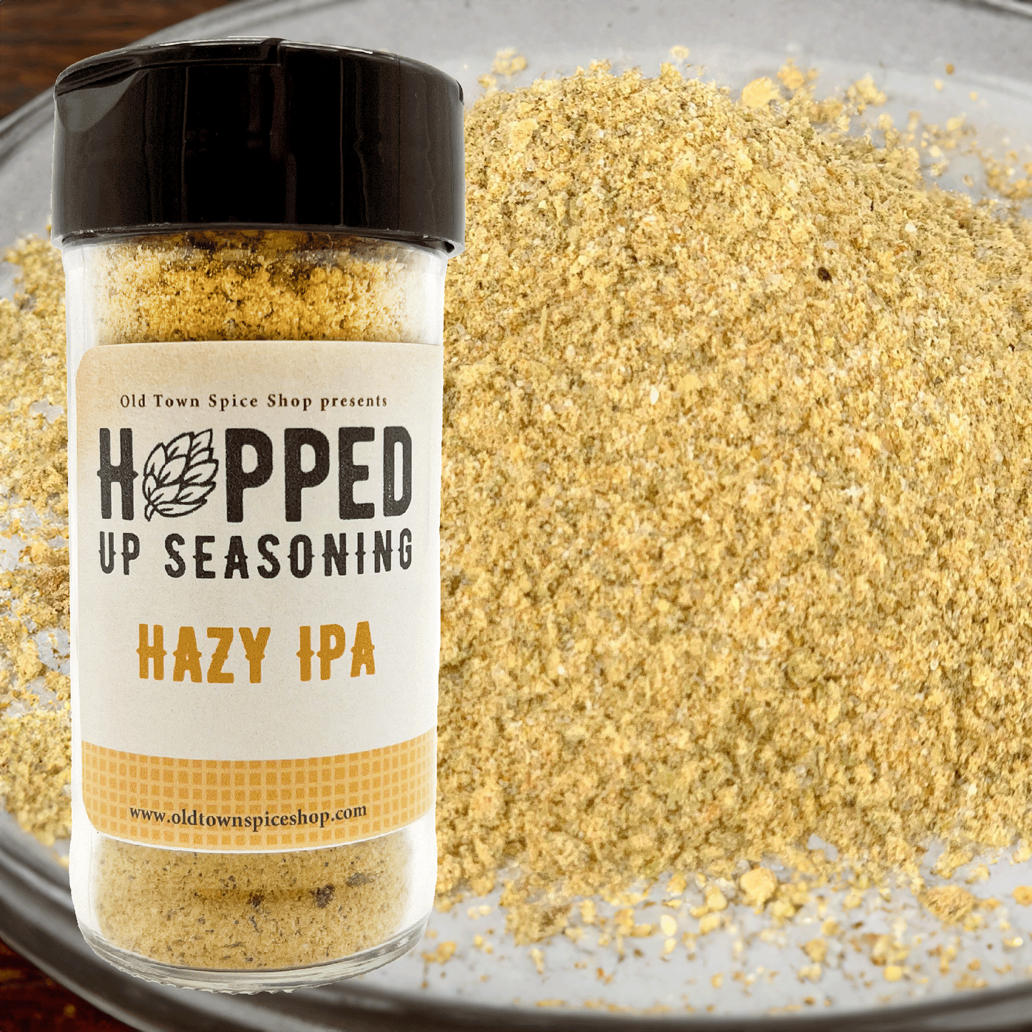 Jar of 'Hopped Up Seasoning Hazy IPA' from Old Town Spice Shop on a glass surface.