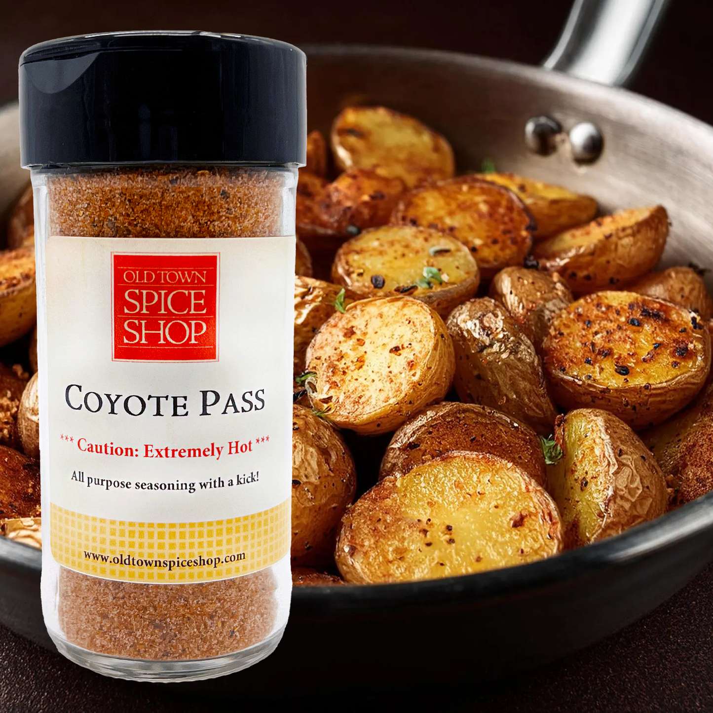 Jar of Old Town Spice Shop Coyote Pass seasoning with roasted potatoes in a pan