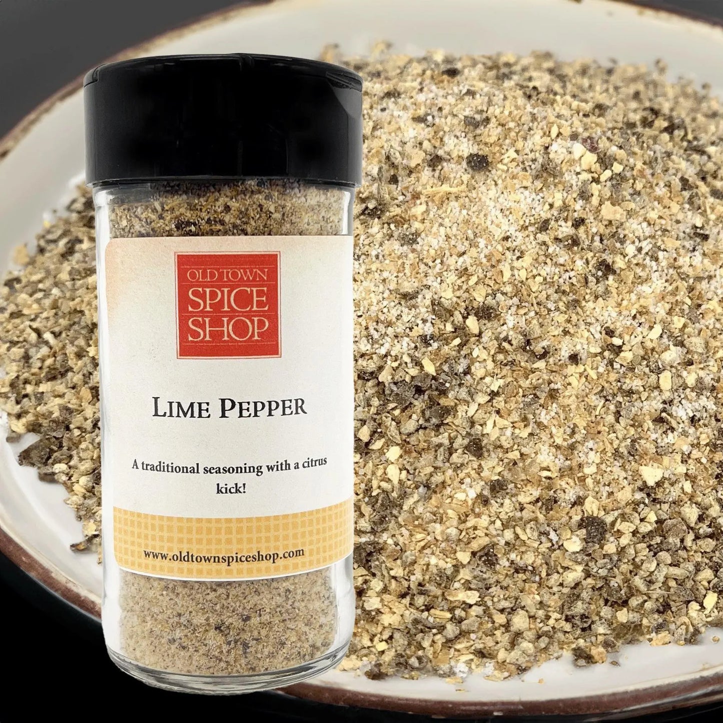 Bottle of Old Town Spice Shop Lime Pepper with a plate of ground pepper in the background